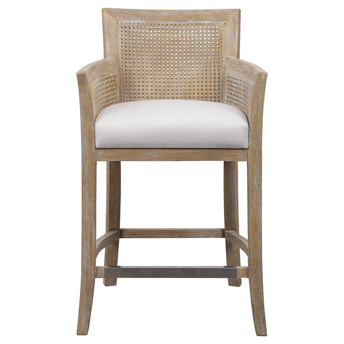 Light brown wicker arm chair stool with white cushion.
