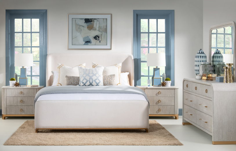 Coastal white and blue bed frame with cream and gold furniture.