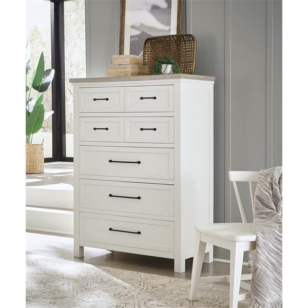 Angled view of white seven drawer dresser in bedroom.