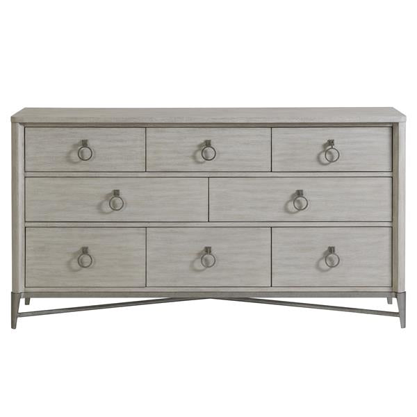 Front of cream eight drawer dresser with round silver pulls.