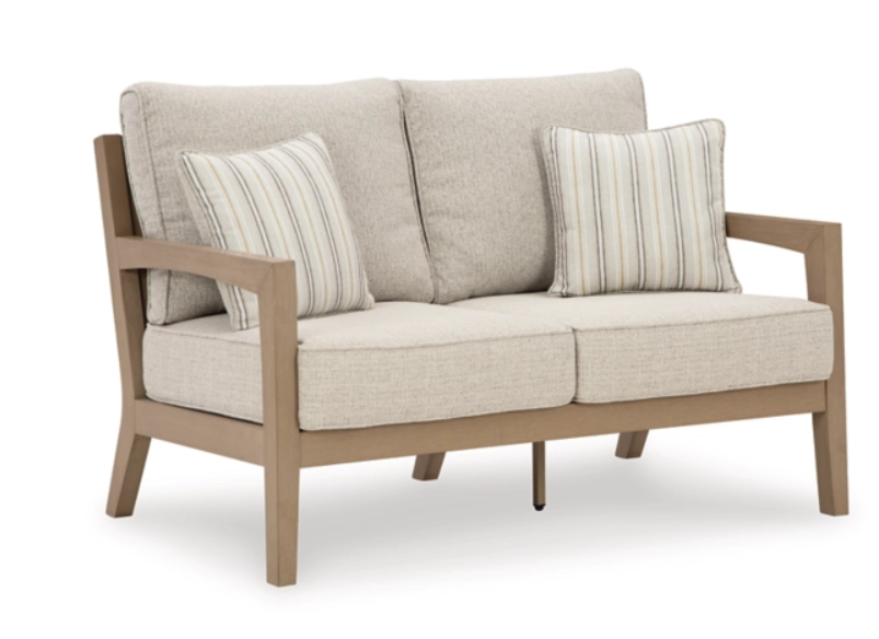 Angled view of exterior sofa with cream cushions.