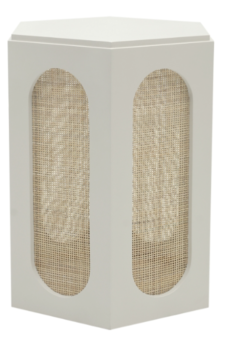 Close up of small white hexagonal table with rattan sides.
