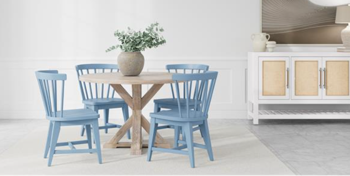 Kitchen with round cream dining table and blue chairs.