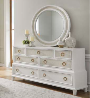 Angled view of white 7-drawer white dresser with gold pulls.