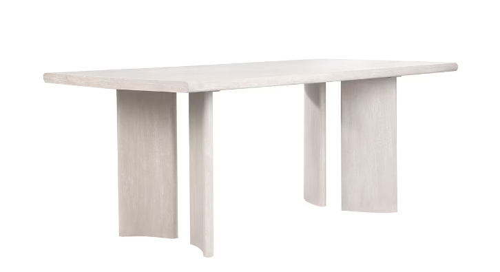 Dirty white rectangular coffee table with wide arched legs.