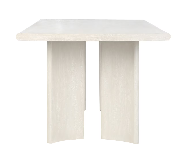 Front of white wood dining table with rounded legs.