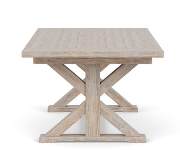 Side view of light brown wood dining table with X style legs.