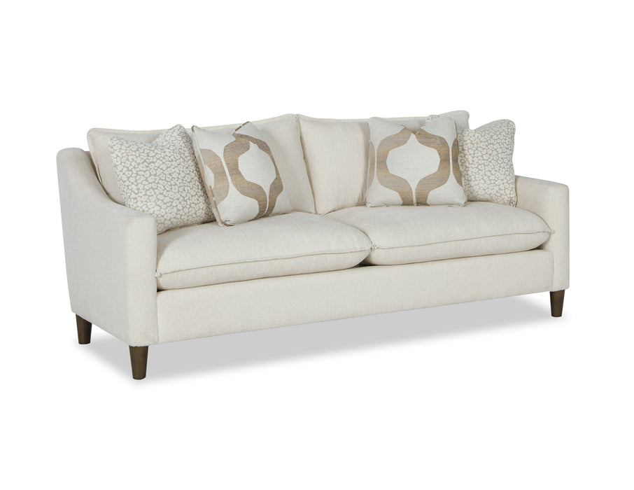 Angled view of cream two cushion sofa with pillows.