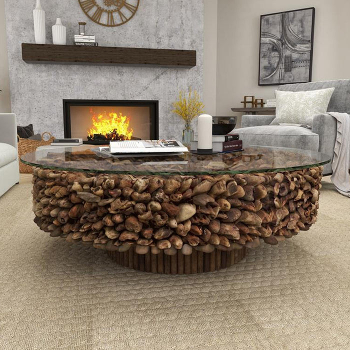 Large round coffee table with shells and glass top.
