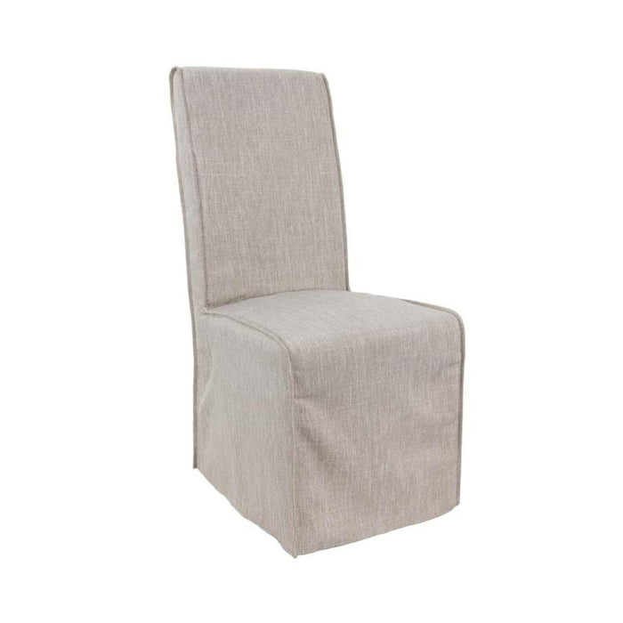 Angled view of dirty sand-colored fabric dining chair.