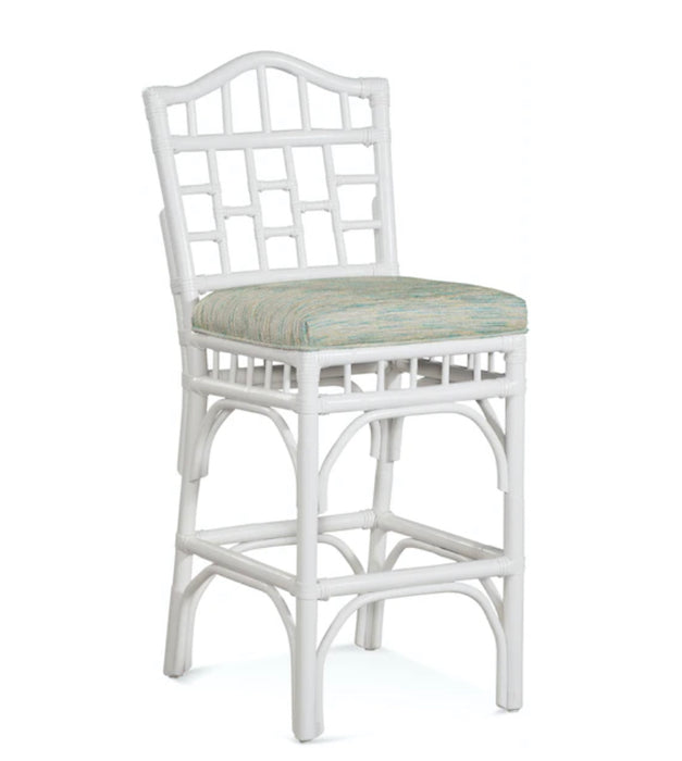 White wood accent chair with green and gold stool.