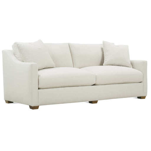Angled view of white loveseat with white pillows and brown legs.