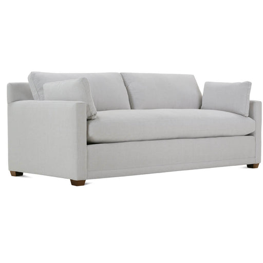 Angled view of white two cushion couch with brown legs.