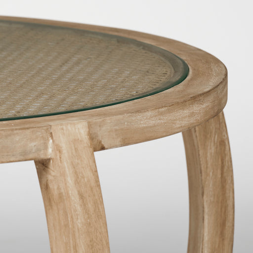 Egde of rustic rounded glasstop coffee table.