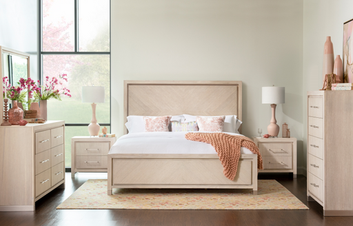 Cream-colored bedroom with beige bedframe, dressers, and rug.