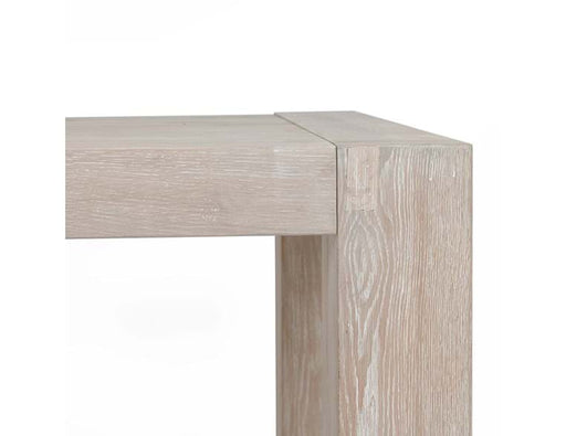 Up close look at corner of light natural brown table.