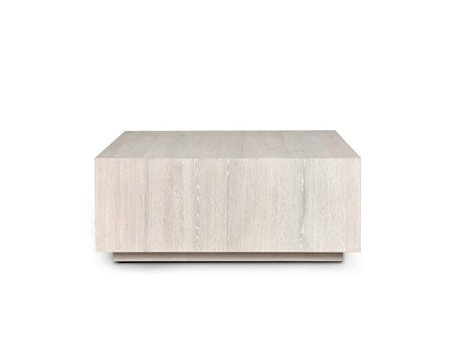 Front of low white wood rectangular coffee table.
