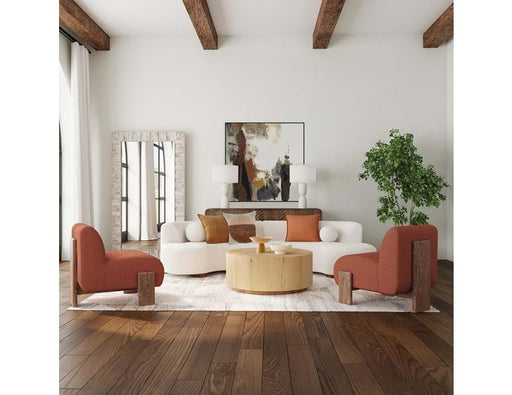 White living room with wood floors and rafter accent, peach furniture.
