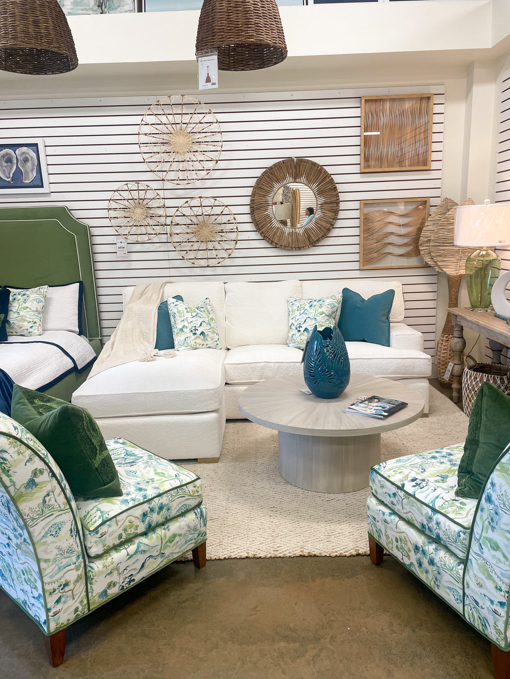 A showcase of loveseats, a bed, accent chairs, and designer wall coverings.