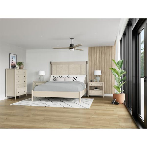 Light brown wood floor bedroom with cream bed, dresser, and side tables.