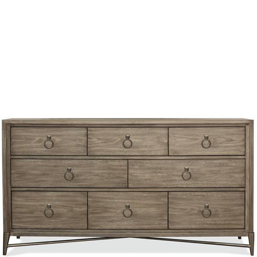 Front of light brown eight drawer dresser with round pulls.