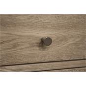 Close up of brown drawer with round pull.