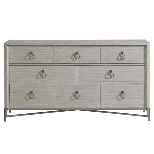 Front of cream eight drawer dresser with round silver pulls.