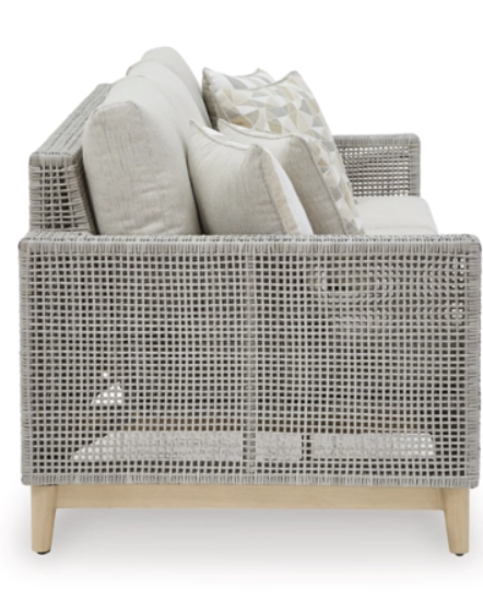 Side view of gray woven exterior sofa with cream cushions.