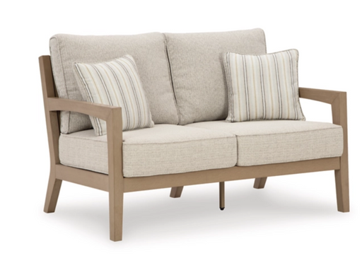 Angled view of exterior sofa with cream cushions.