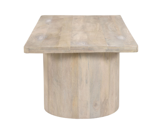 Rustic sand-colored rectangular table with round bottom.