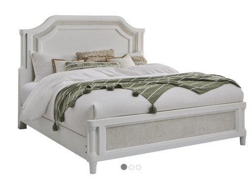 Cream and rattan bed frame with carved headboard.