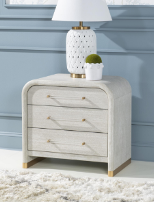 Diagonal view of rounded cream and gold side table.
