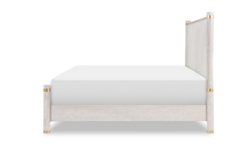 Side of cream and gold bed frame with mattress.