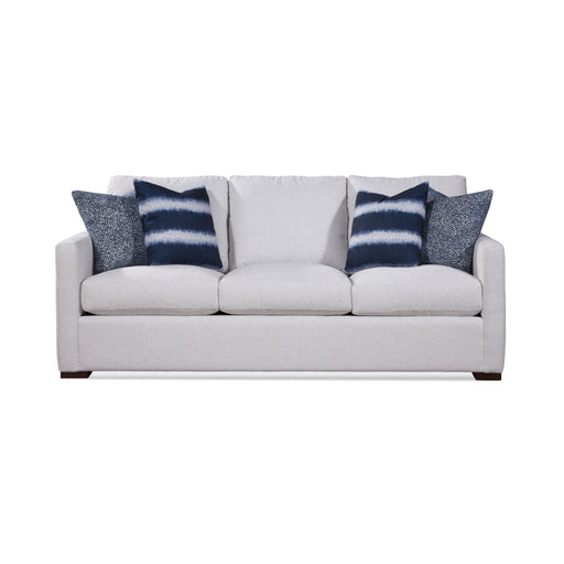 White three cusion sofa with blue accent pillows.