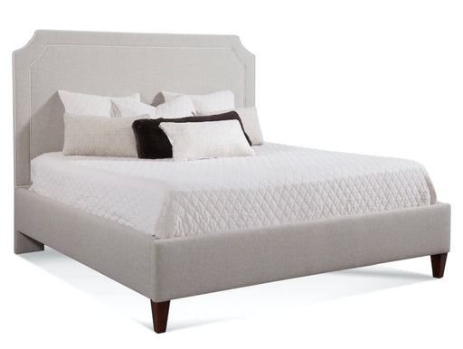 Cream colored bed frame with arched headboard and mattress.