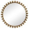 Small image of round gold mirror with gold ball accents.
