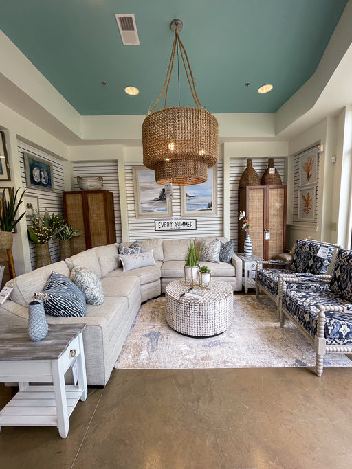 Long view of white slat wall living room with blue and cream furniture.