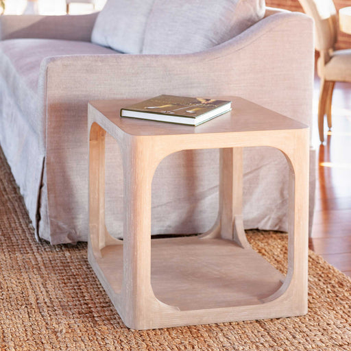 Sand-colored open center side table next to couch.