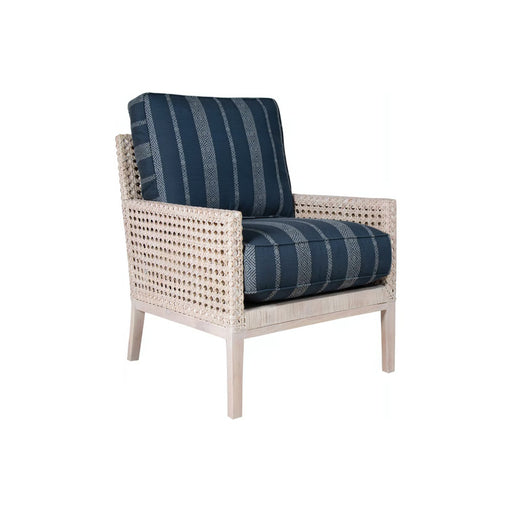 Diagonal shot of wicker mesh chair with blue cushion.