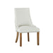 Elegant dining room furniture featuring a white fabric dining chair with rivet accents.