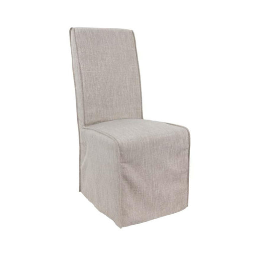 Angled view of dirty sand-colored fabric dining chair.