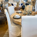 Natural dining room sets with fresh white upholstered chairs.