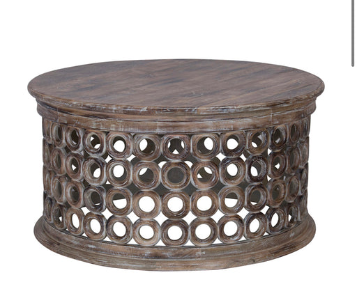 Rustic round wood coffee table with circle detail on outer edge.