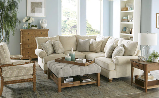 Baby blue living room with cream and brown wood furniture.