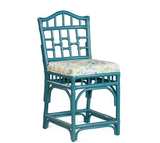 Teal wood accent chair with white floral cushion.
