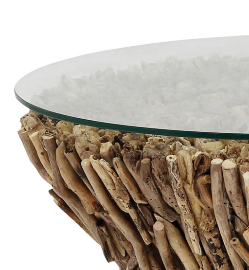 Edge of glass top coffee table with driftwood stand.