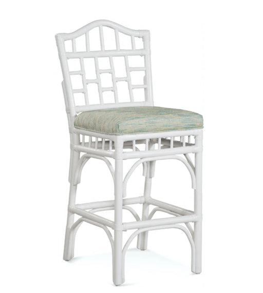 White wood accent chair with green and gold stool.