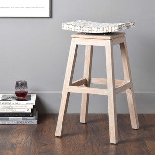 Sand colored stool with rounded white cushion.