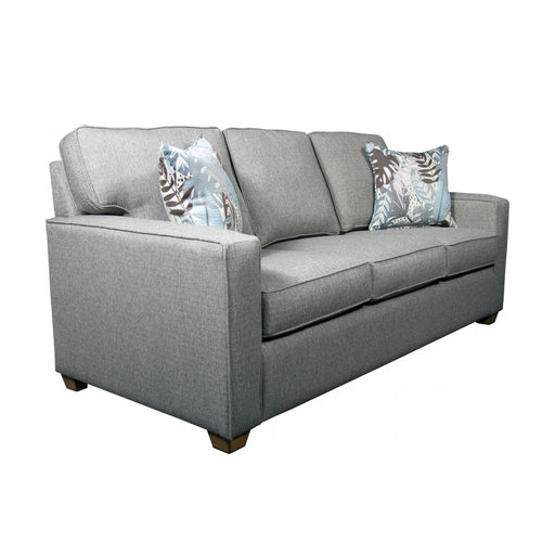 Angled view of light gray three seat couch with blue and white pillows.