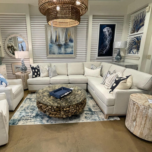 Inside cream colored living room blue accents and basket pendant light.